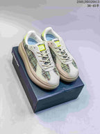 Pair of multicolor Onitsuka Tiger Delecity low-top sneakers on a shoebox