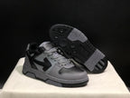 Angled view of the sneakers with one shoe lifted to reveal the patterned rubber outsole.
