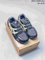 Pair of ASICS Hypersync sneakers in dark navy and cream displayed on a shoebox, with the style code and size range visible above.