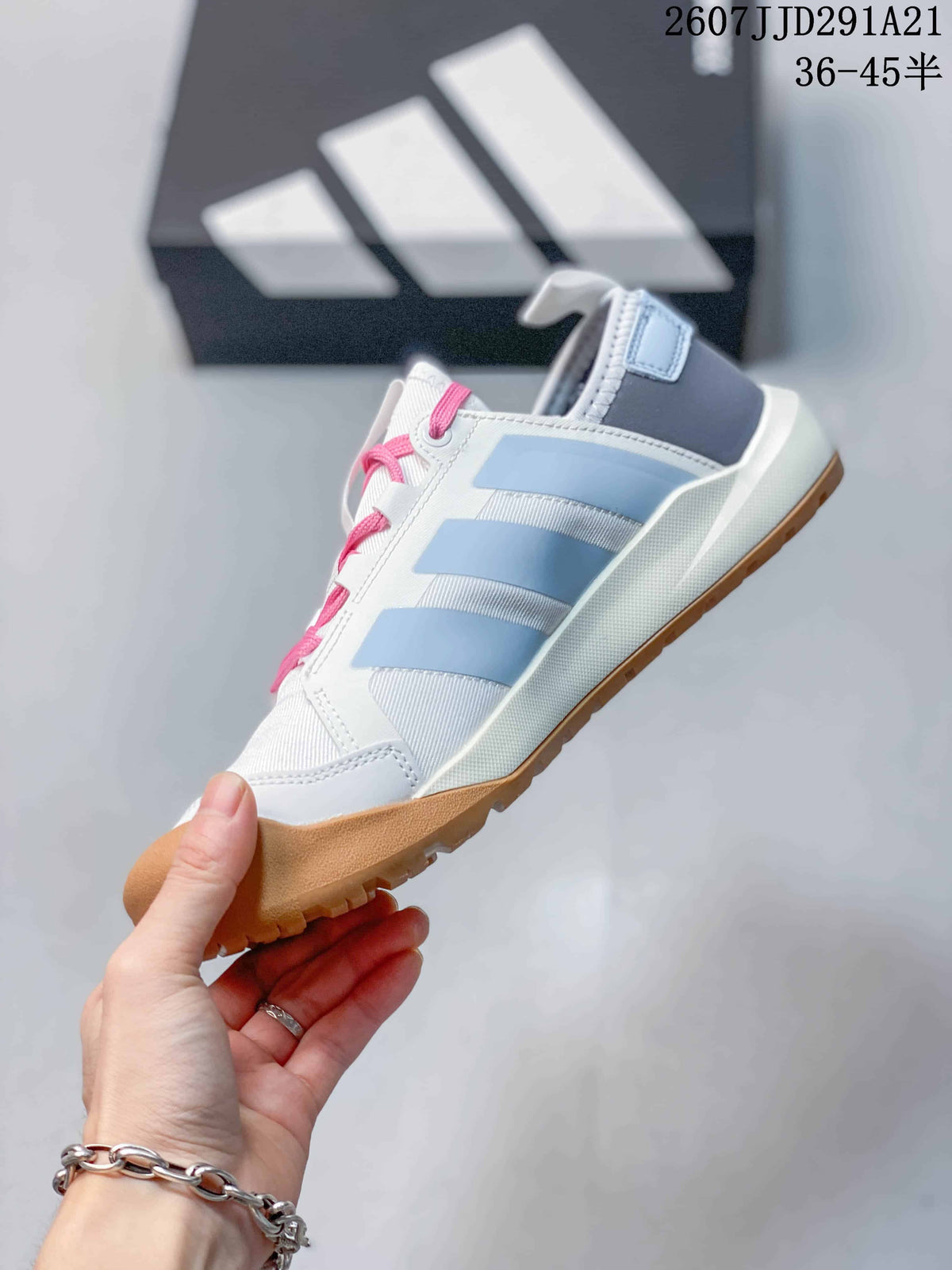 Side view highlighting the pale blue stripes, white upper, pink laces and gum-colored outsole.