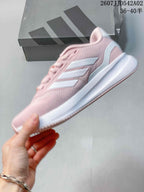 Side view of the pink running shoe with white stripes and a white midsole.