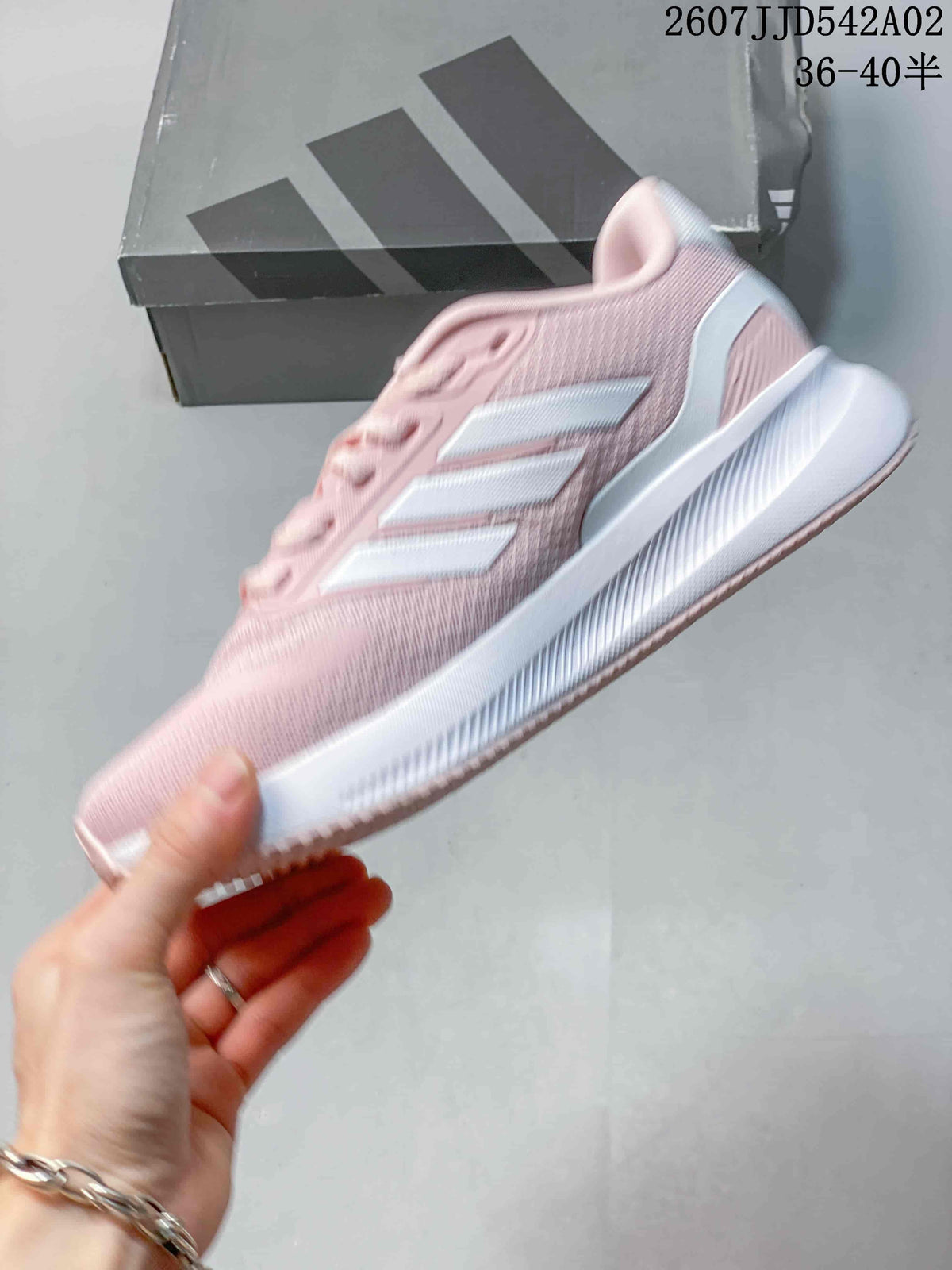 Side view of the pink running shoe with white stripes and a white midsole.