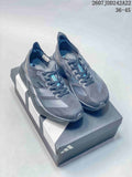 Pair of dark gray Y-3 Adios Pro 4 low-top sneakers displayed on a branded shoe box.