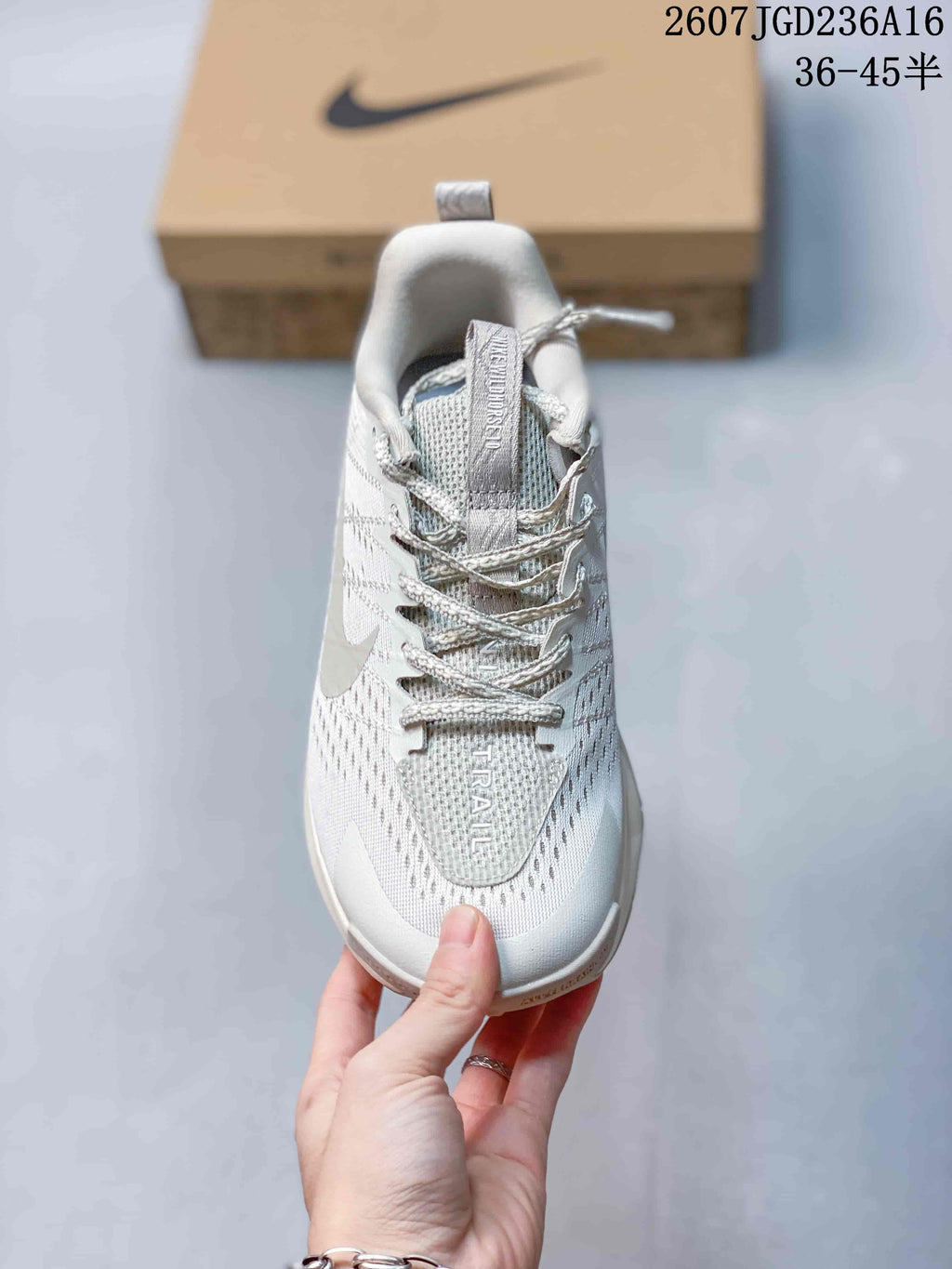 Top view of the shoe showing the laces, padded collar, textured upper, tongue branding, and the word TRAIL on the forefoot.