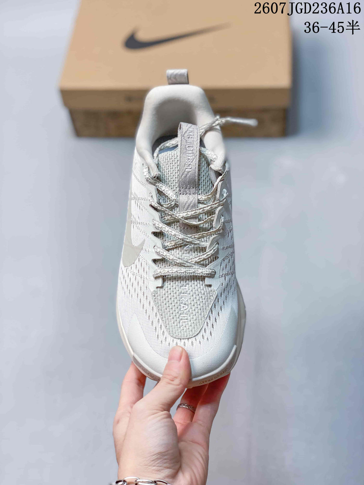 Top view of the shoe showing the laces, padded collar, textured upper, tongue branding, and the word TRAIL on the forefoot.