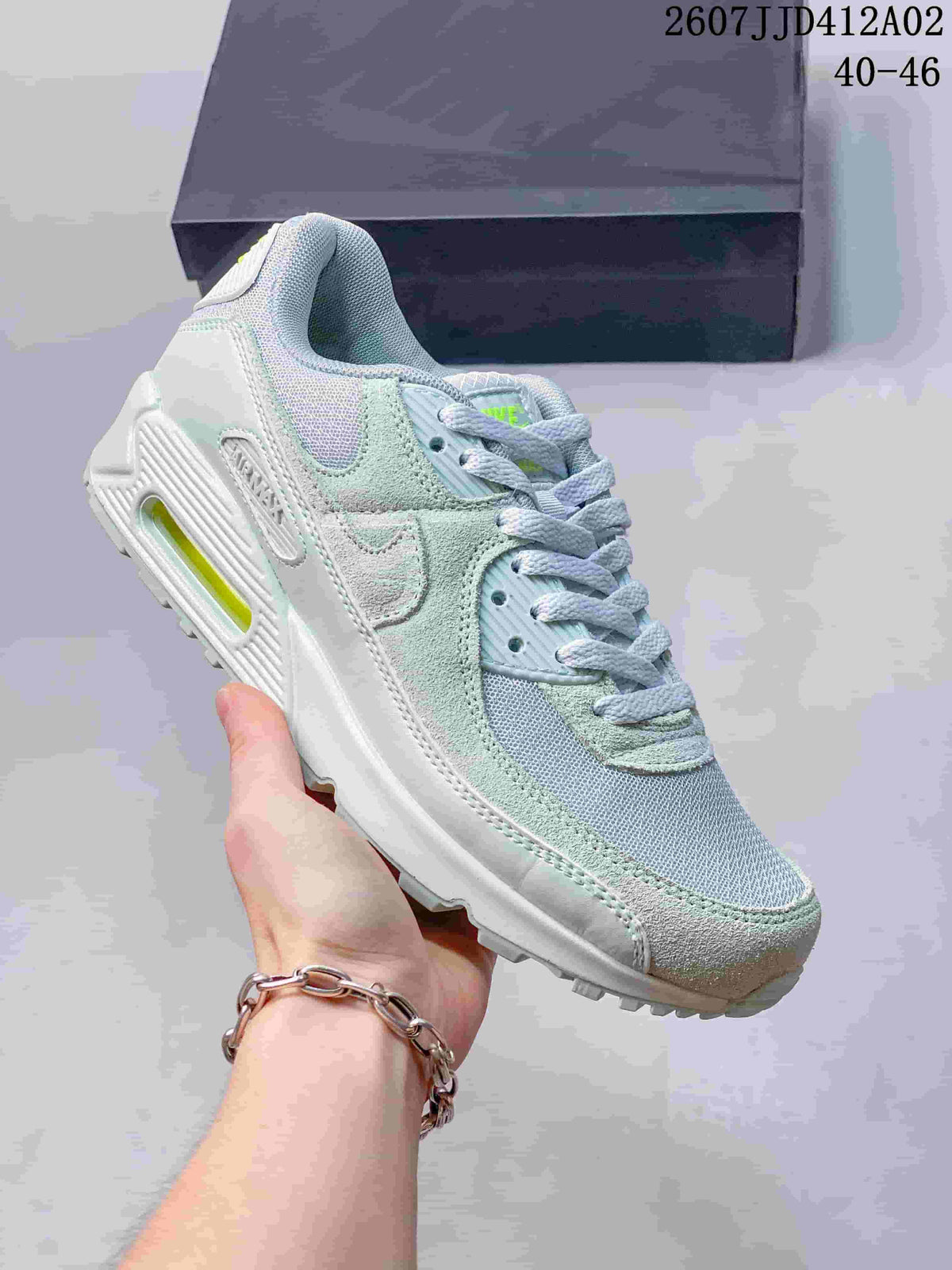 Angled side view of the pale blue and mint Nike Air Max 90 sneaker.