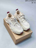 Pair of off-white On Cloudsolo sneakers with burgundy accents displayed on a shoebox.