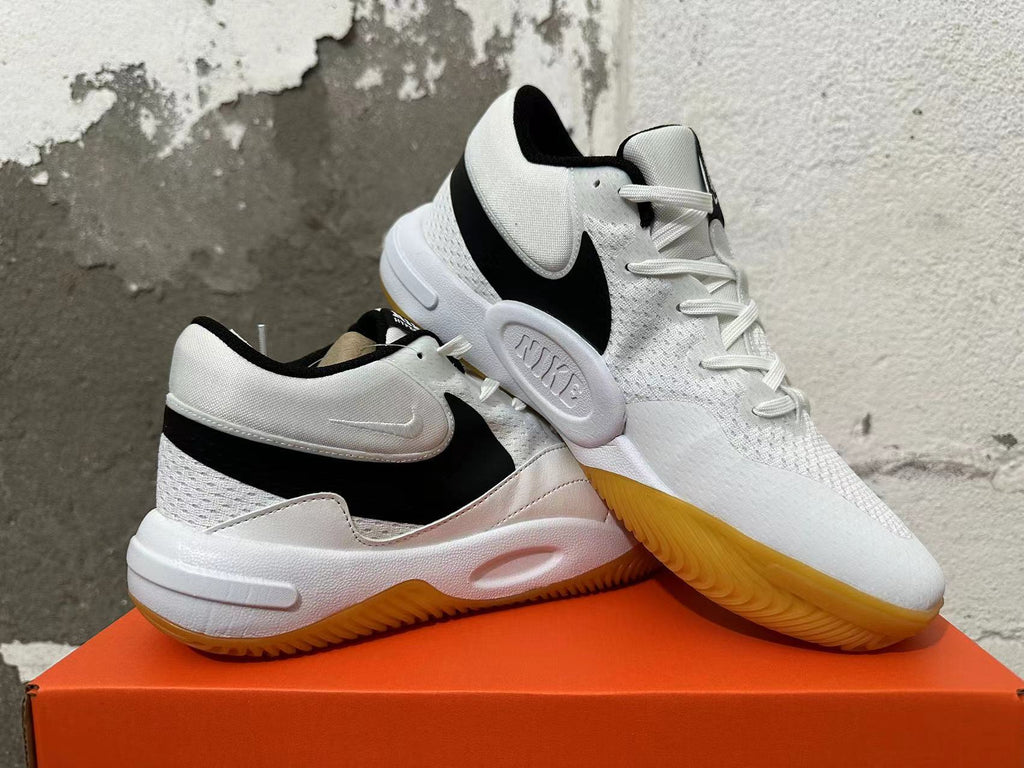 Pair of white and black Nike Hyperquick low-top shoes shown at an angle