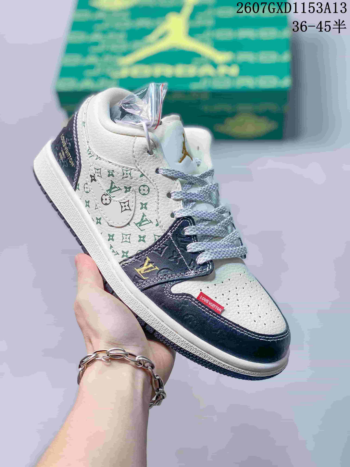 Angled side view showing the patterned side panel, dark navy overlays, white upper, and green presentation box.