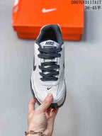 Top view showing the black laces, white upper and Nike Initiator tongue branding.