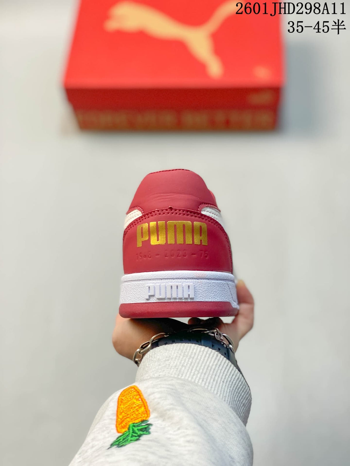 Rear view showing the red heel, gold Puma branding, and white midsole.
