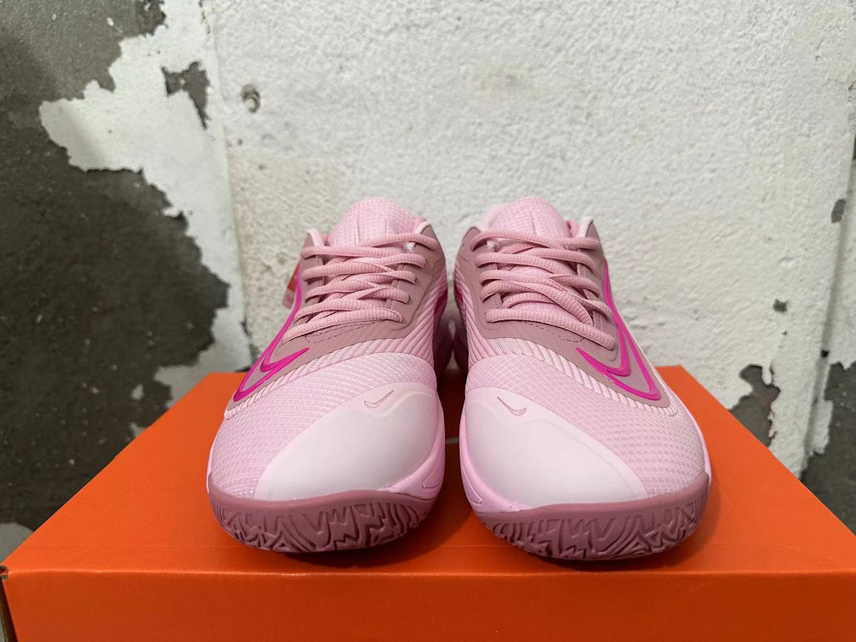 Front view of pink Nike Precision 7 basketball shoes with bright pink Swoosh accents