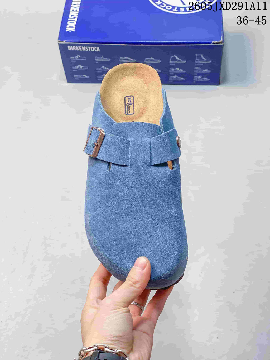 Top view showing the rounded toe, blue upper, two buckle straps, and contoured footbed.
