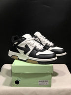 Black and white Off-White Out Of Office sneakers displayed with a green shoebox; the box label shows size 42.