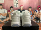 Rear view of white Jordan sneakers showing padded heels, heel branding, pull tabs, and translucent outsole sections.