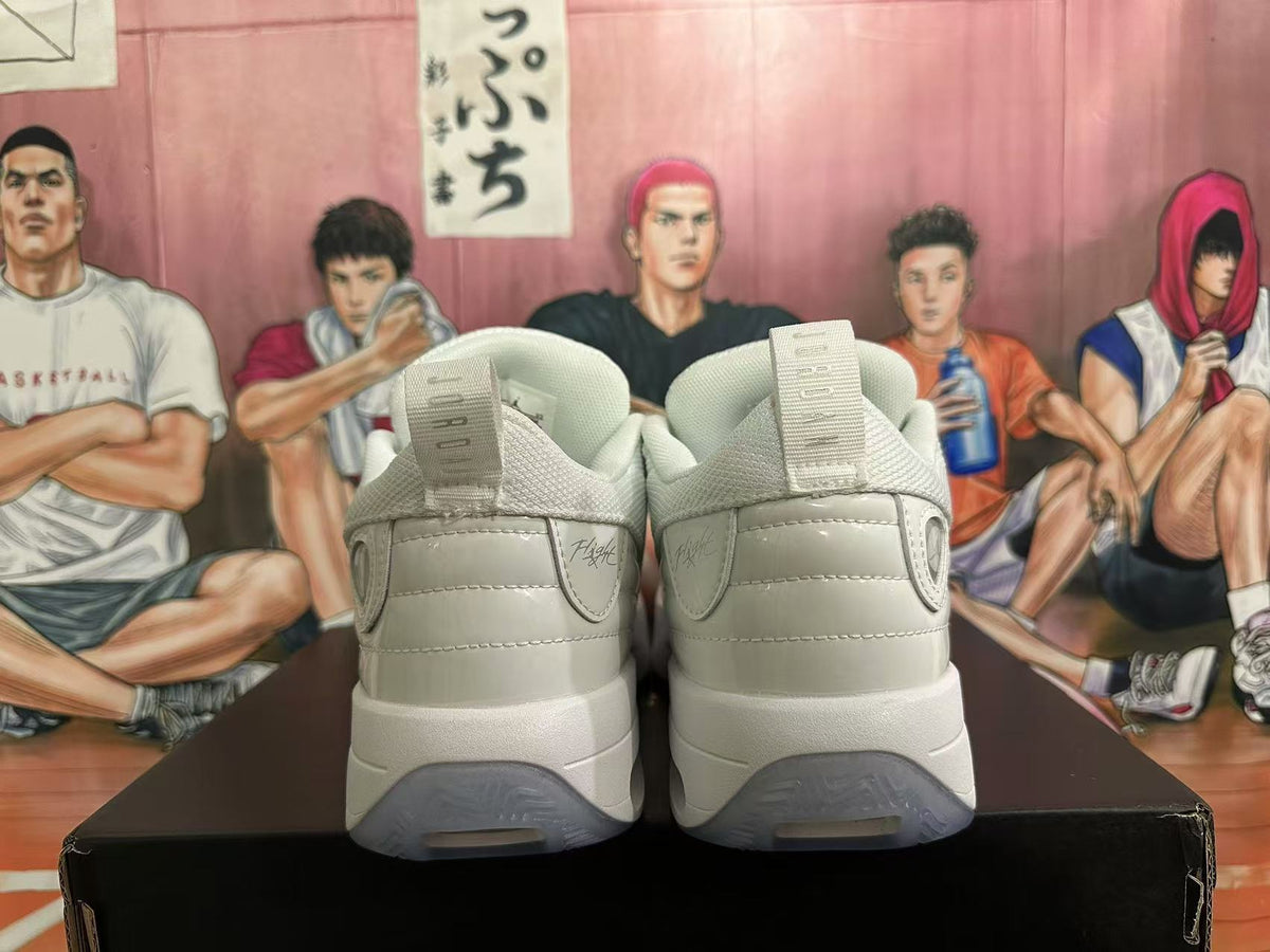 Rear view of white Jordan sneakers showing padded heels, heel branding, pull tabs, and translucent outsole sections.