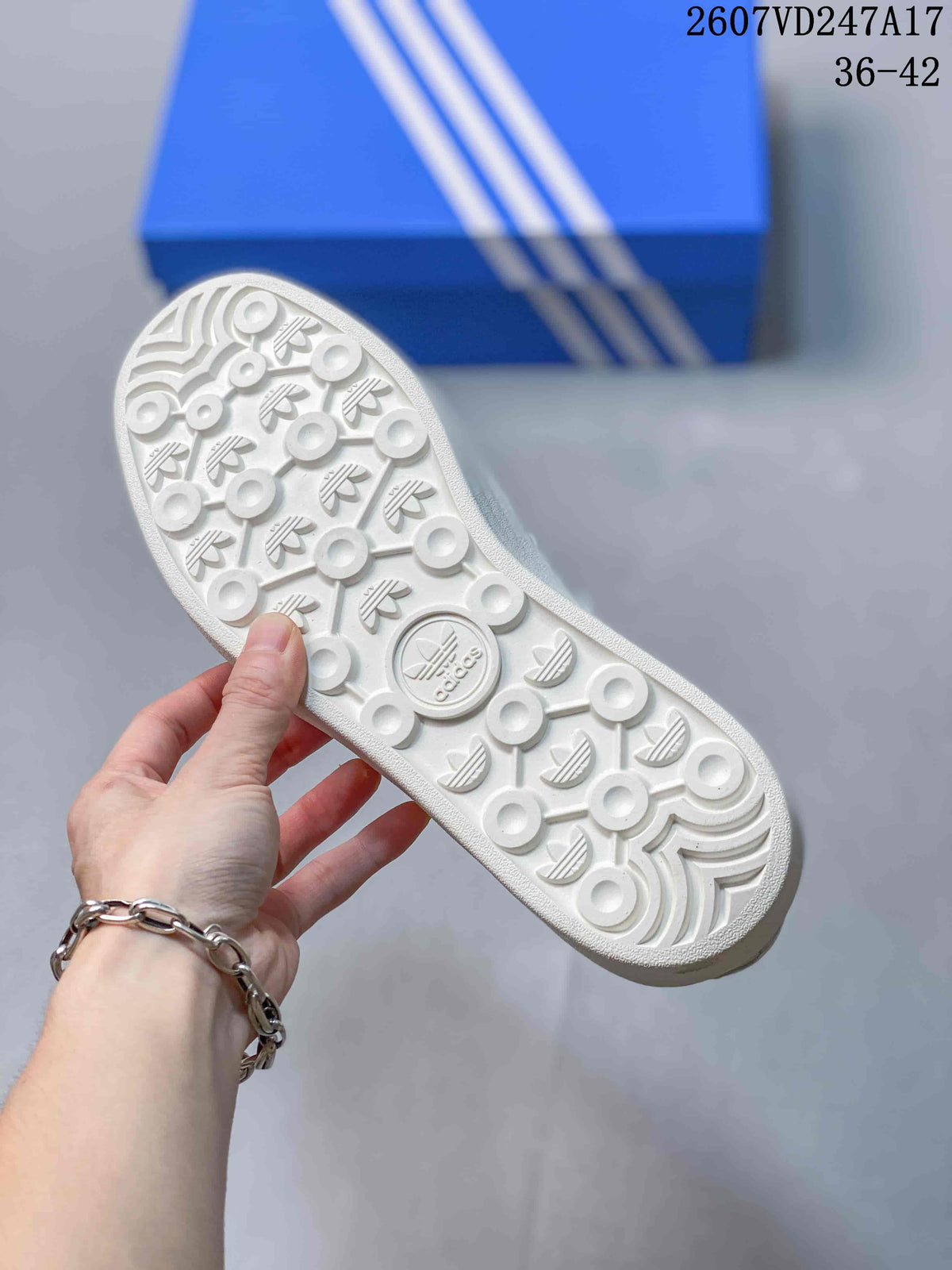 White outsole of the sneaker showing circular tread elements and adidas trefoil motifs.