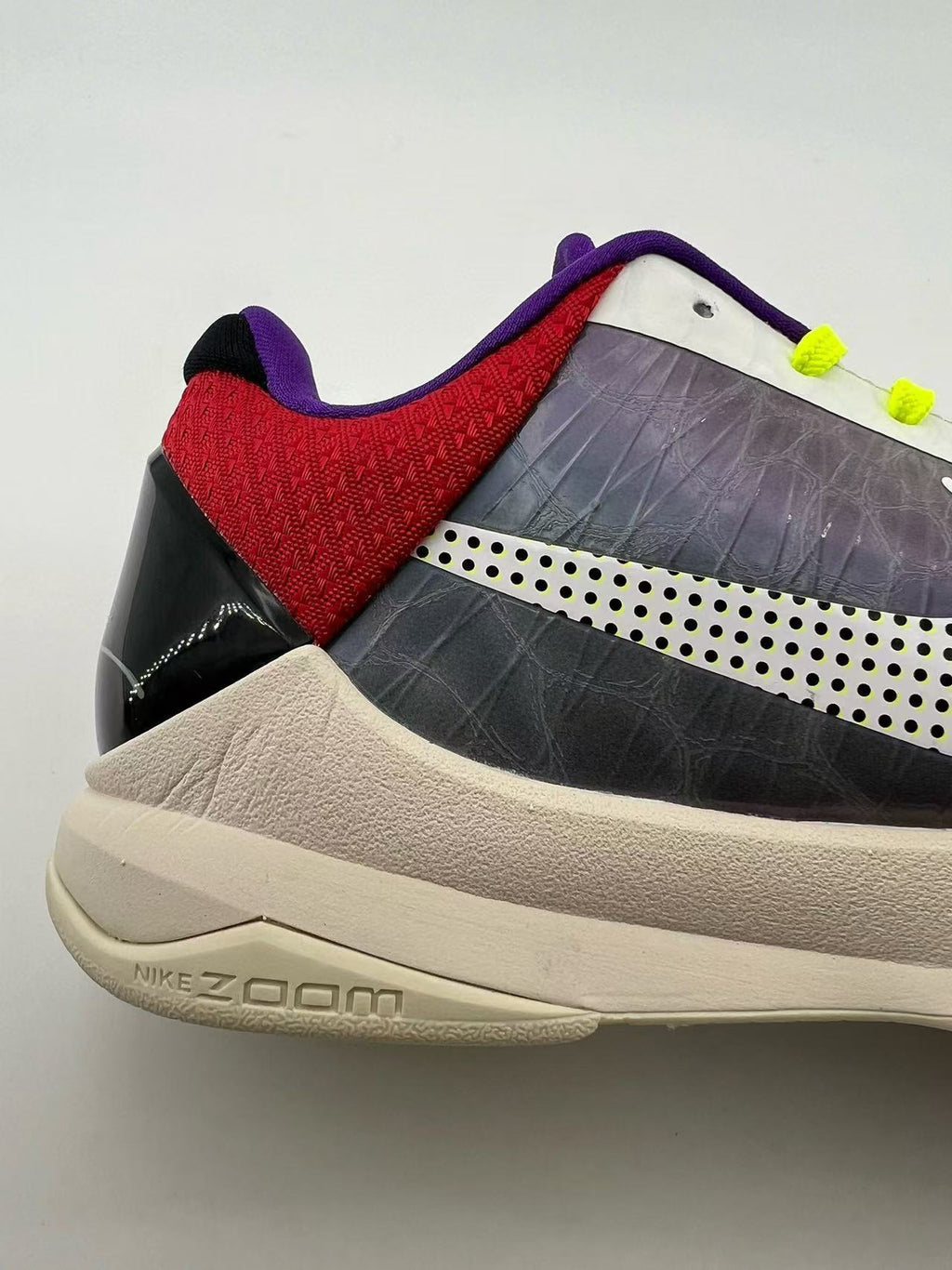Close-up of the shoe heel, red collar panel, and side logo