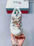 Top view of the sneaker showing the lace-up construction, textured toe area, and decorative lace charm.