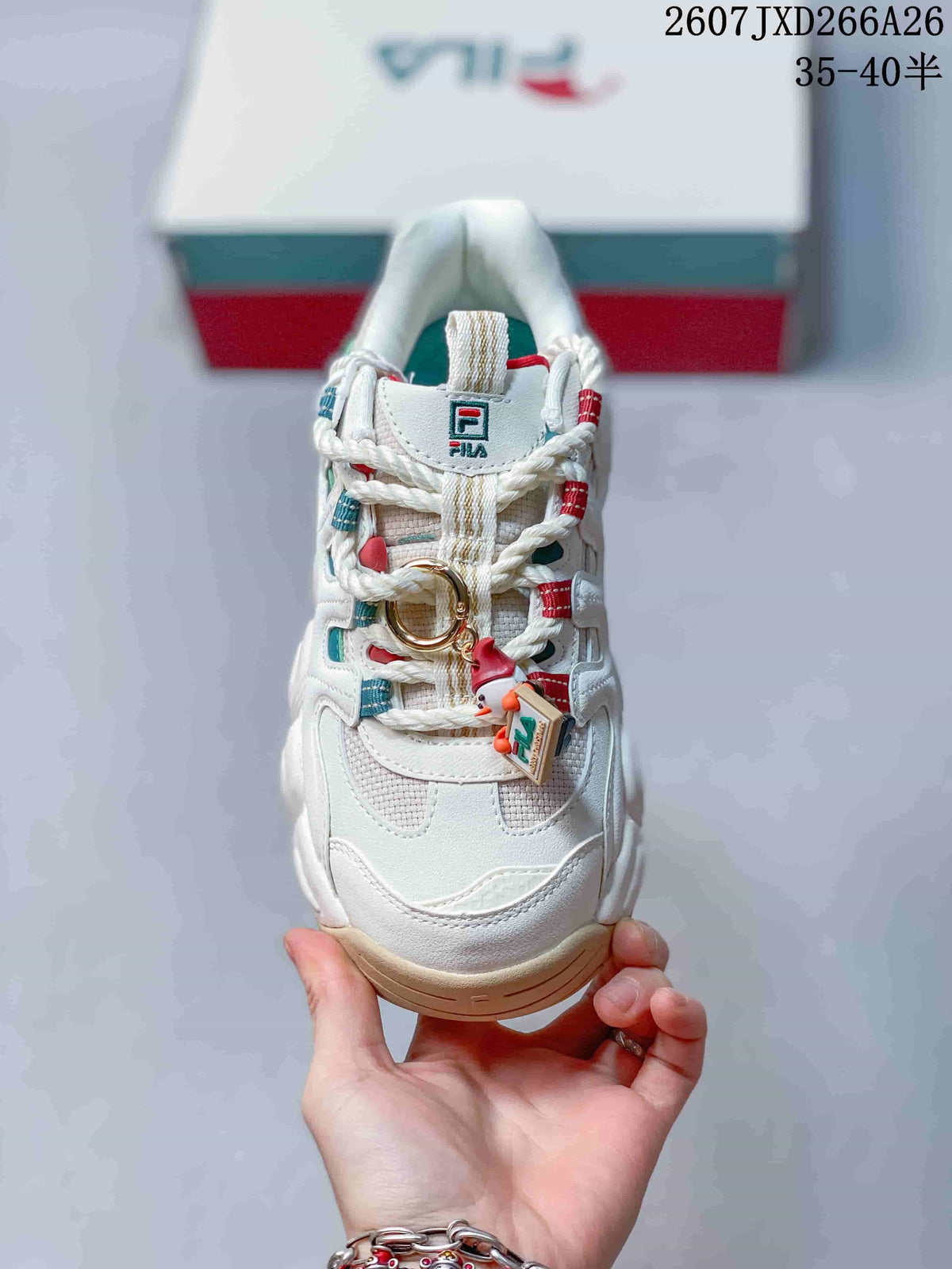 Top view of the sneaker showing the lace-up construction, textured toe area, and decorative lace charm.