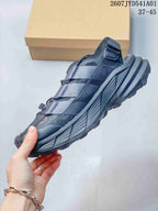 Side profile of a dark gray outdoor shoe with layered panels and rugged outsole