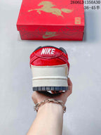 Heel view of a red and cream Nike SB Dunk Low sneaker