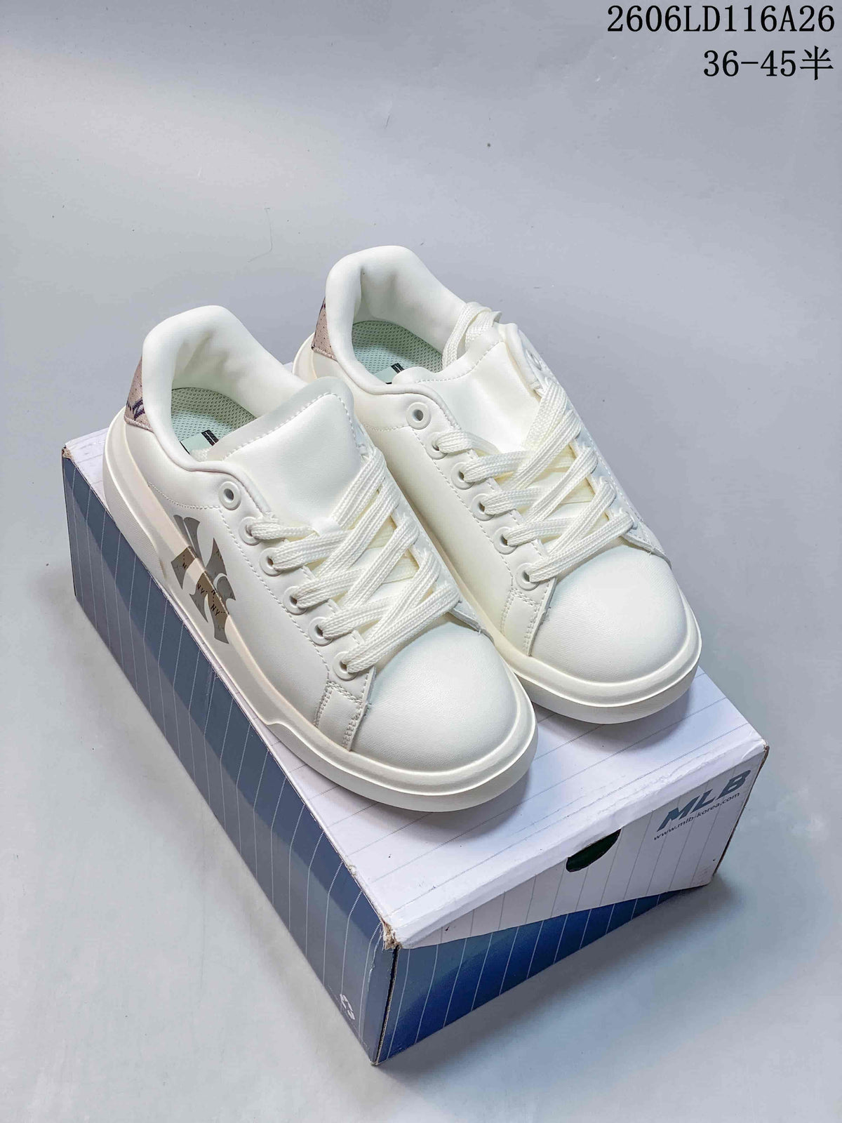 Pair of white MLB low-top sneakers displayed on a branded shoebox.