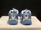 Rear view showing padded collars, heel panels, pull tabs, and blue outsole construction.