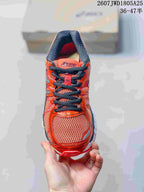 Front view showing the mesh toe box, black laces, and red-orange upper.