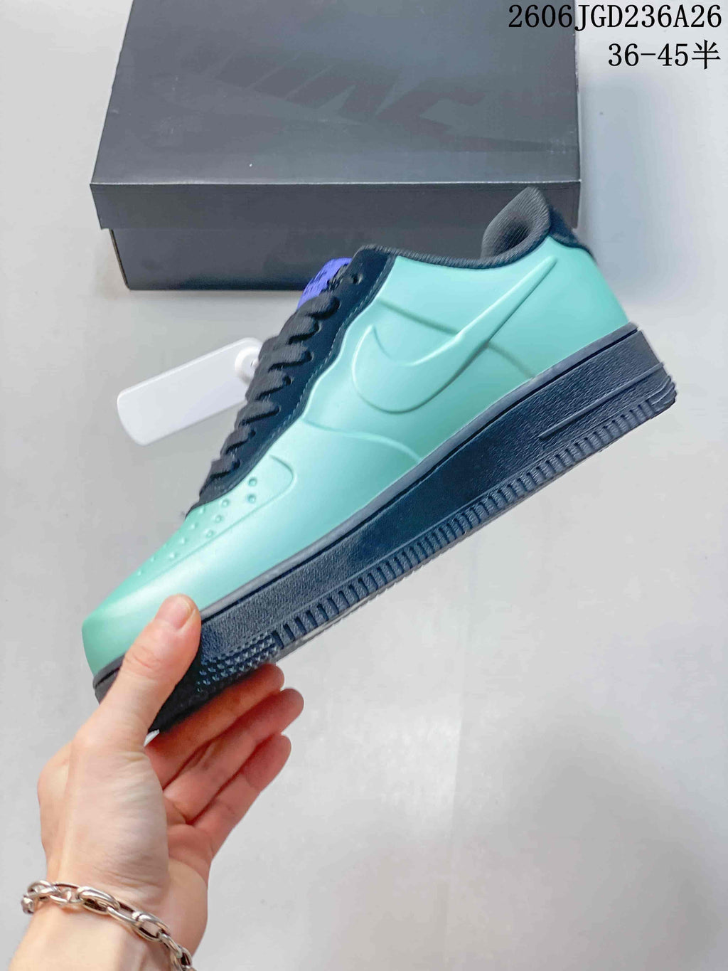 Side view of a mint-green sneaker with navy Swoosh detail and dark sole
