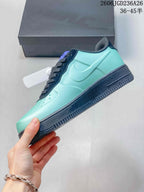 Side view of a mint-green sneaker with navy Swoosh detail and dark sole