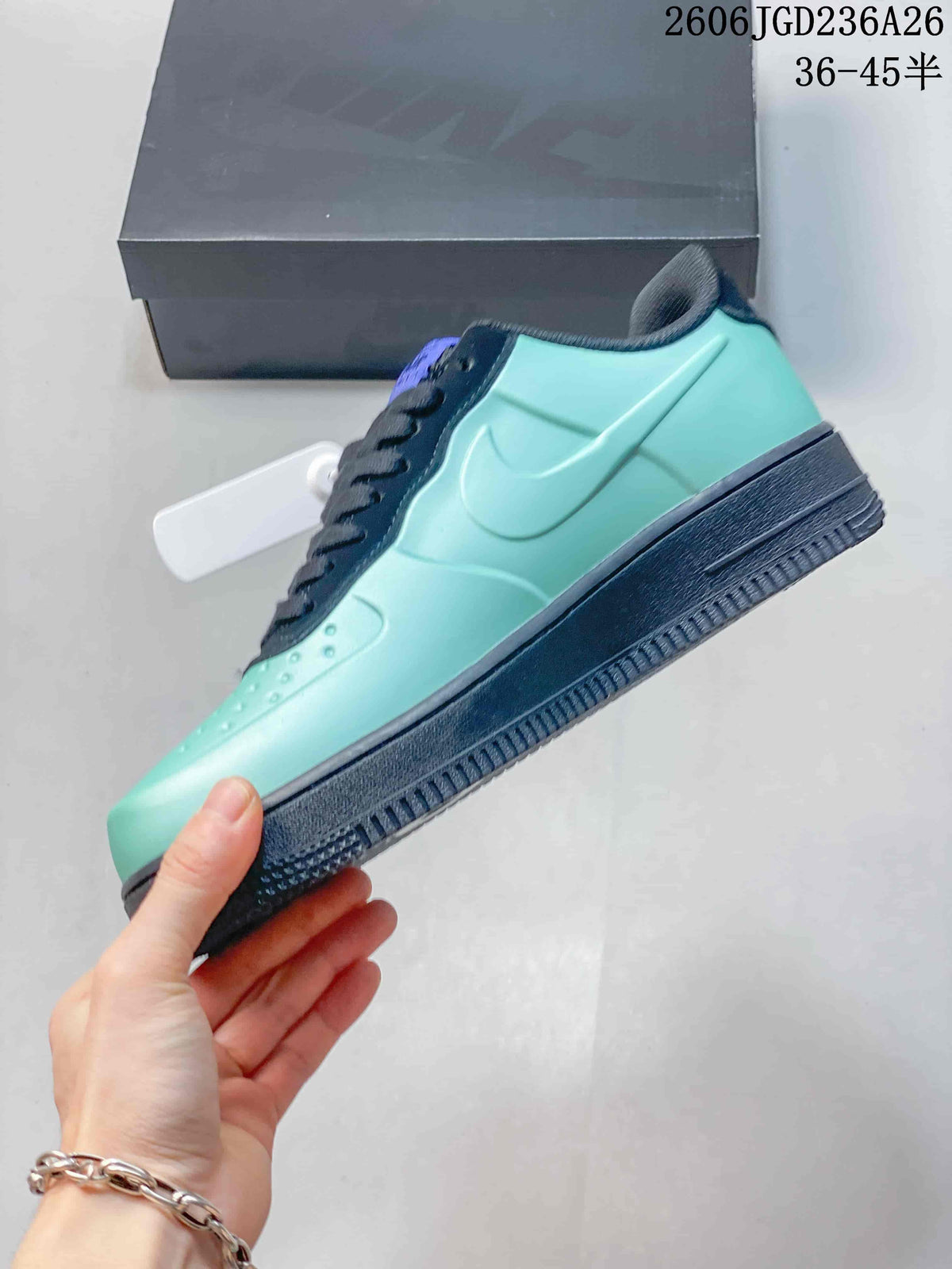 Side view of a mint-green sneaker with navy Swoosh detail and dark sole