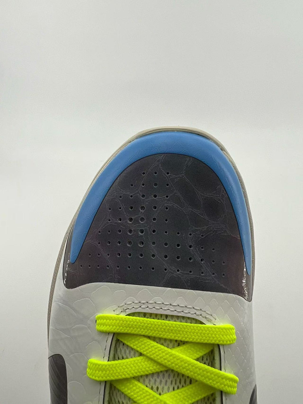 Top-down view of the perforated toe and neon yellow laces
