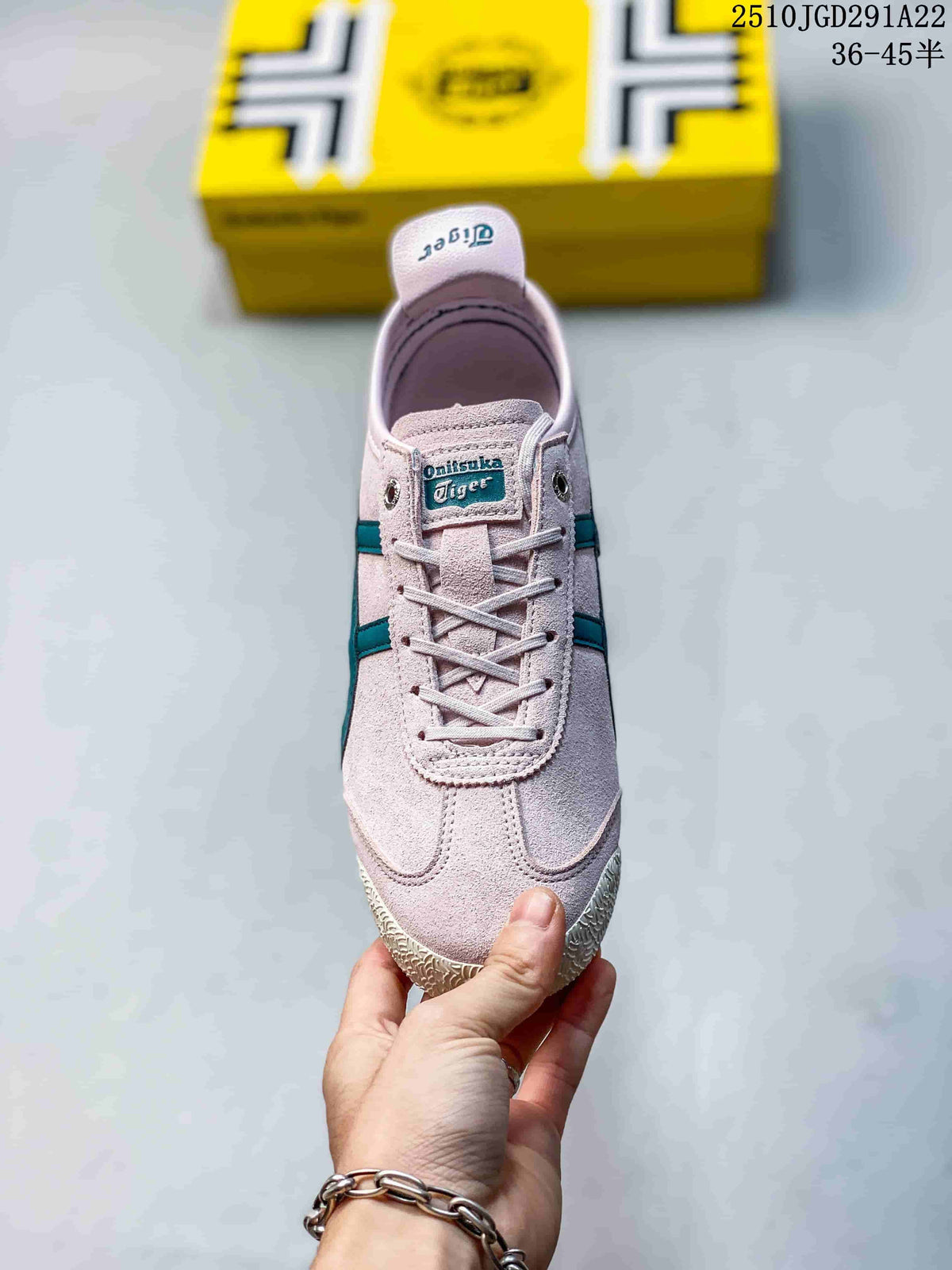 Front view of the pink lace-up sneaker showing the Onitsuka Tiger tongue label, teal side accents and textured toe area.