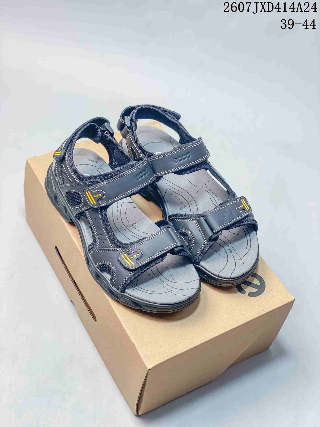 Pair of dark black ECCO open-toe sandals displayed on a shoebox, with the style code 2607JXD414A24 and size range 39-44 visible above.