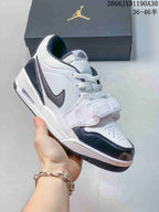 Angled side view of a white and dark Jordan Legacy 312 Low sneaker