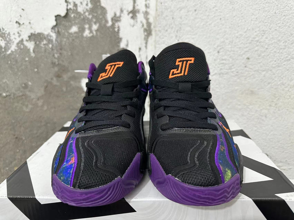 Front view of black Jordan basketball shoes with purple accents and orange tongue logos.