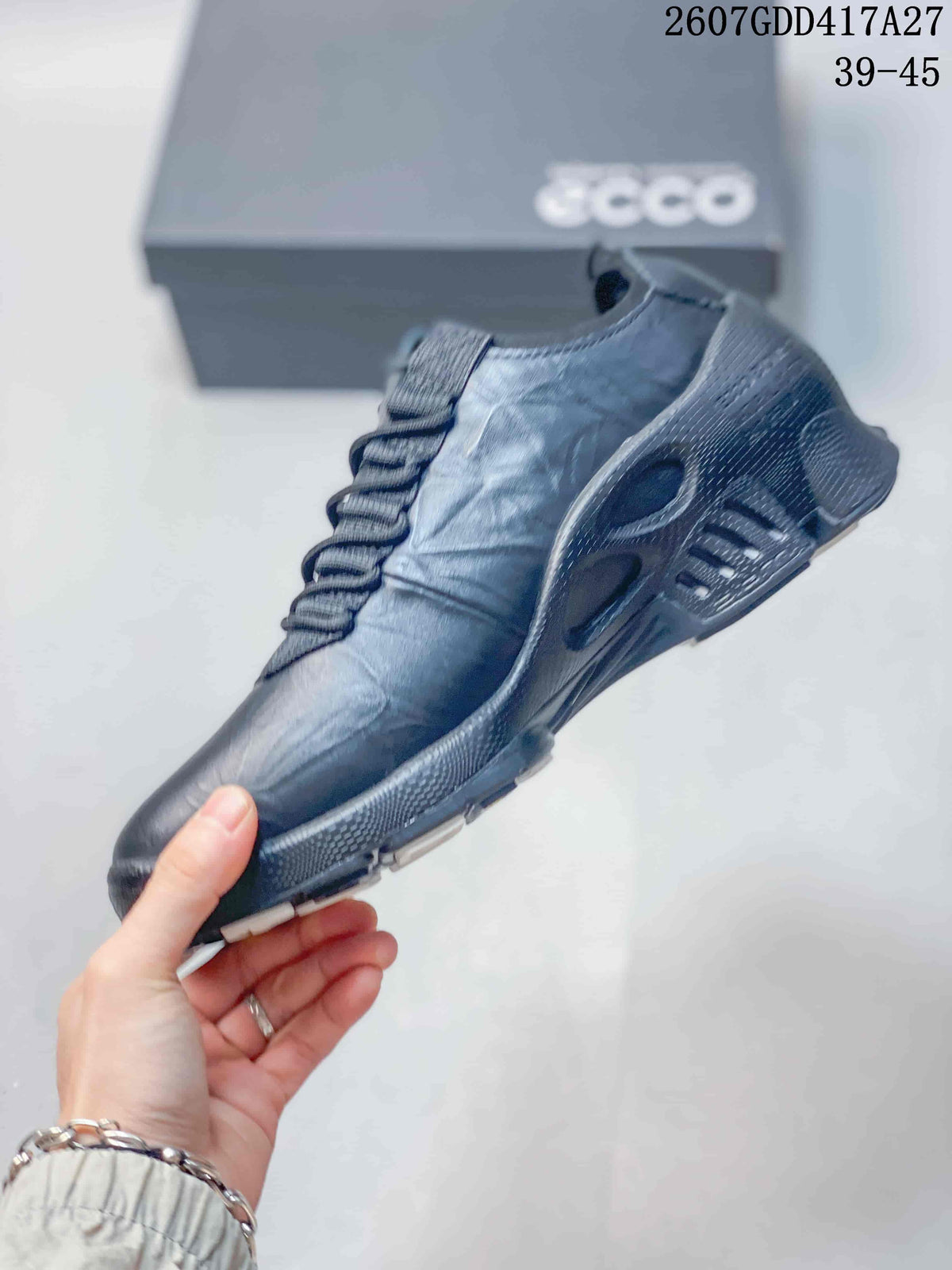 Side view of the dark lace-up sneaker showing the layered upper, raised heel structure, and segmented outsole.