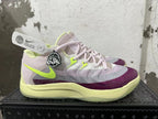 Side view showing the Nike swoosh and white, purple, and pale lime color blocking.