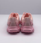 Rear view of the pink sneaker pair showing padded heel collars, heel panels, and runner text.