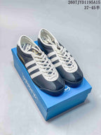Pair of navy and white adidas Italia SPZL sneakers displayed on a blue shoebox.