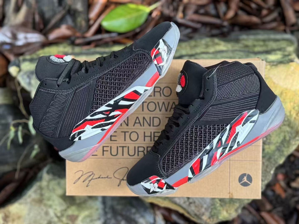 Pair of black Jordan XXXVIII basketball shoes shown from multiple angles