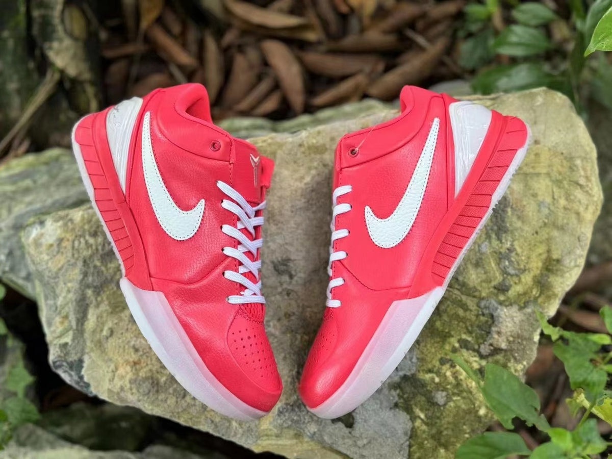 Pair of pink and white Nike Kobe 4 shoes viewed from above.