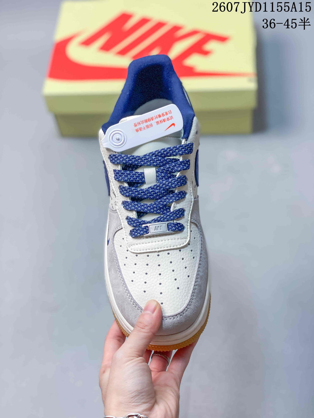 Top view of the sneaker showing the perforated white toe box, blue laces and blue tongue details.