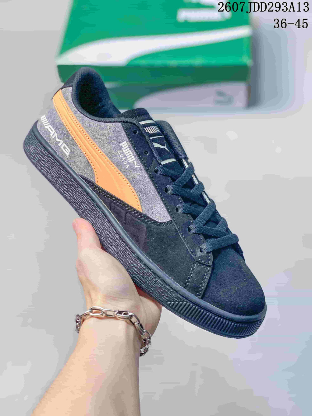 Dark gray and black PUMA BMW M Motorsport sneaker with an orange side stripe and black outsole.