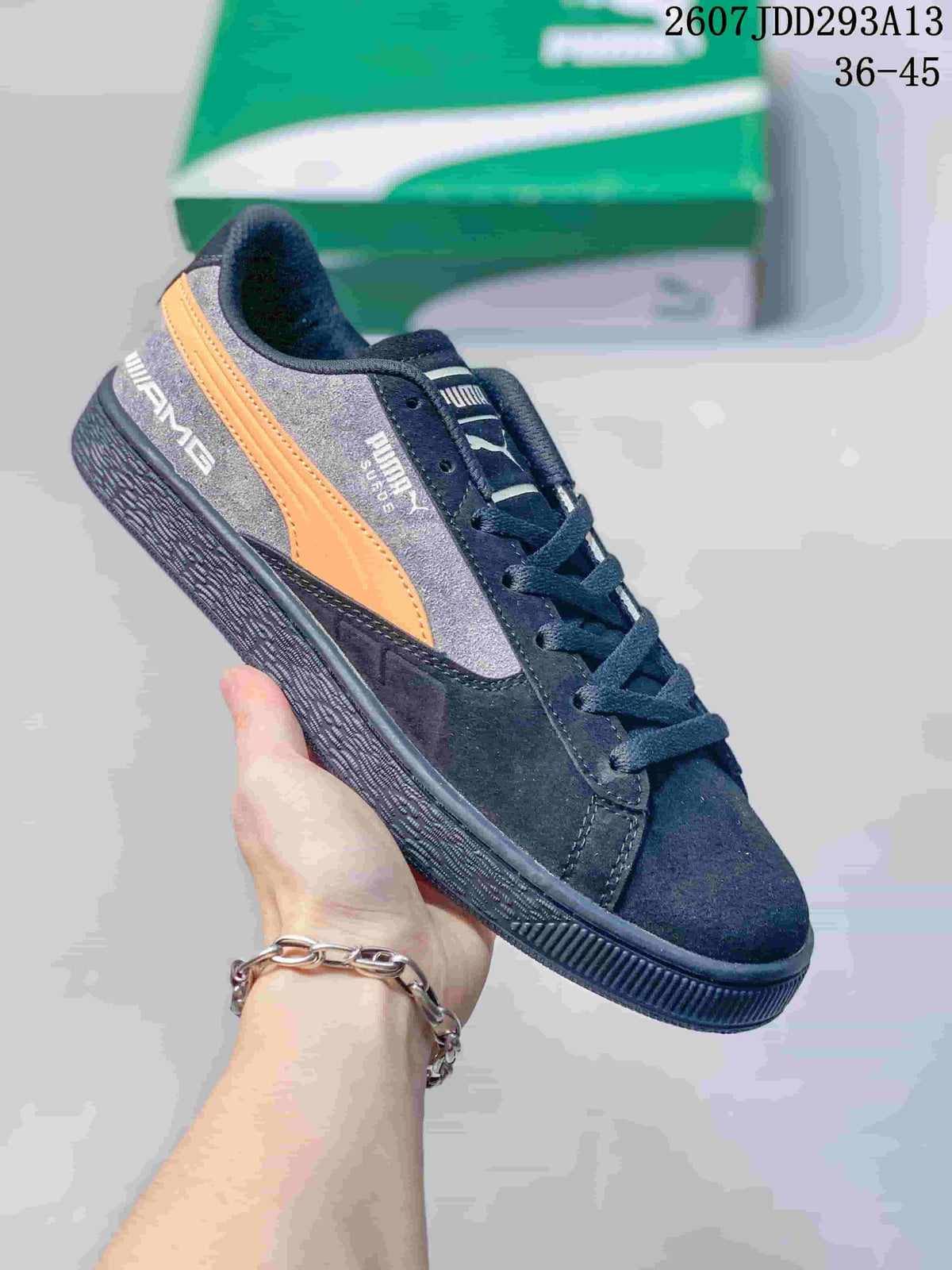 Dark gray and black PUMA BMW M Motorsport sneaker with an orange side stripe and black outsole.