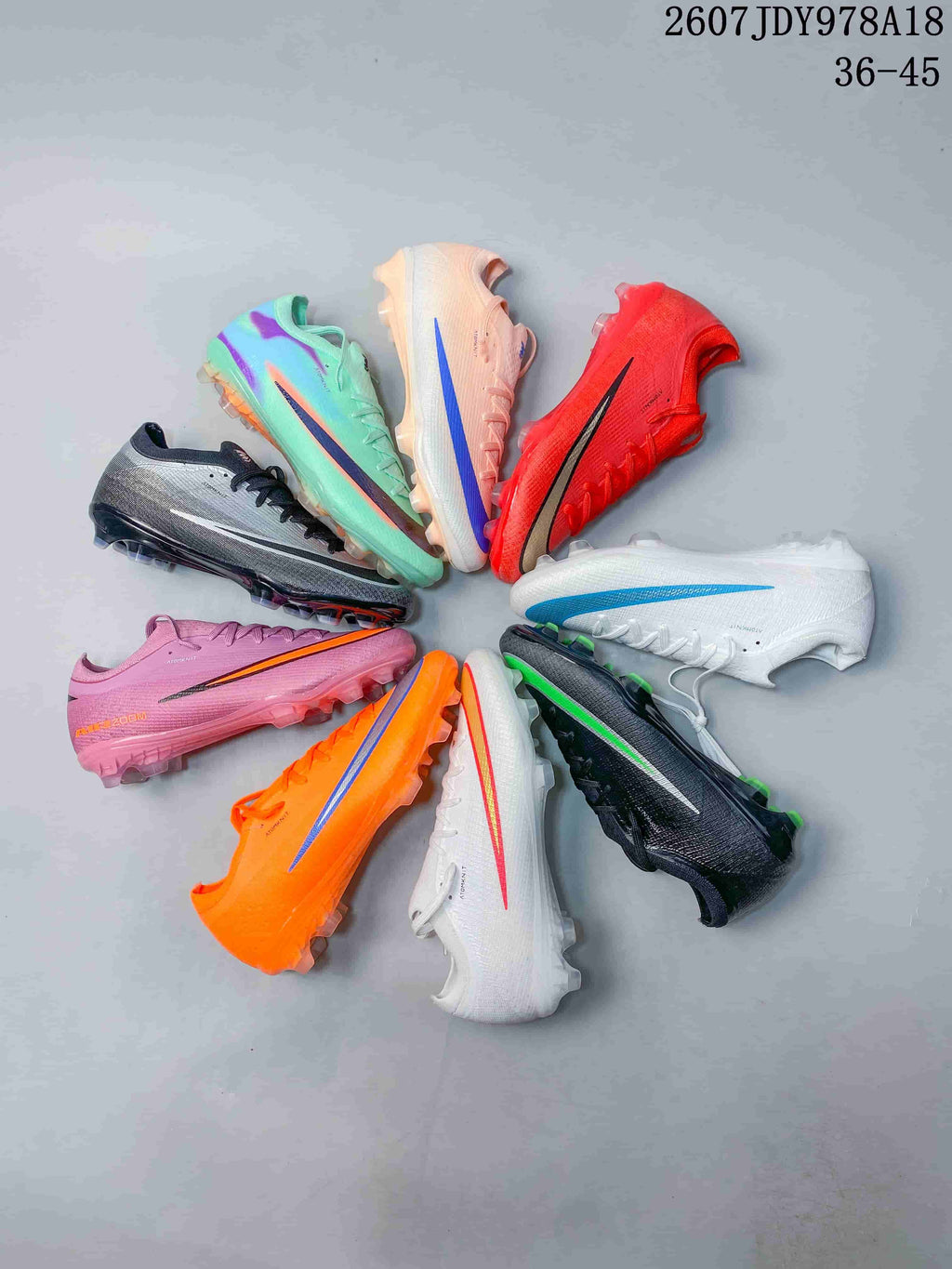 Group display showing multiple colorways of the Nike soccer cleat, including orange, white, pink, mint, black and red designs.