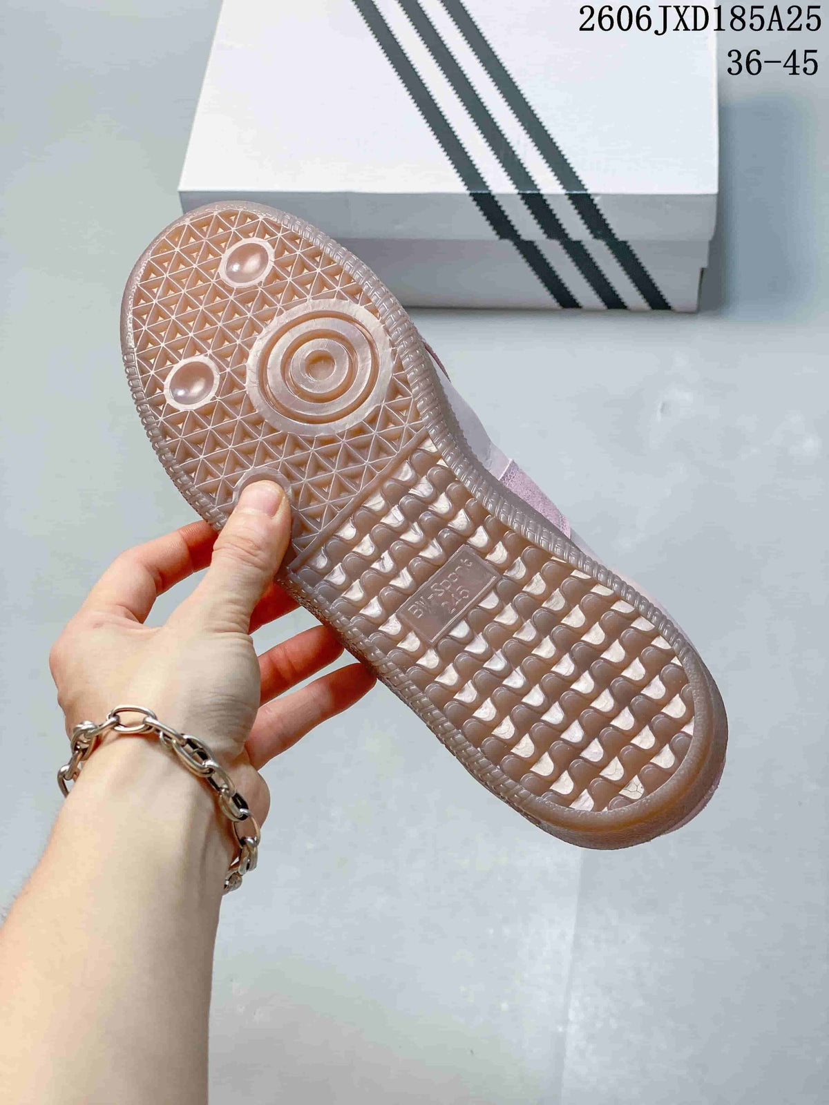 Close-up of the textured translucent gum-colored outsole on a pink sneaker.
