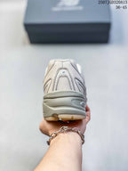 Rear view of the cream sneaker showing the padded heel area, mesh panel and layered sole.