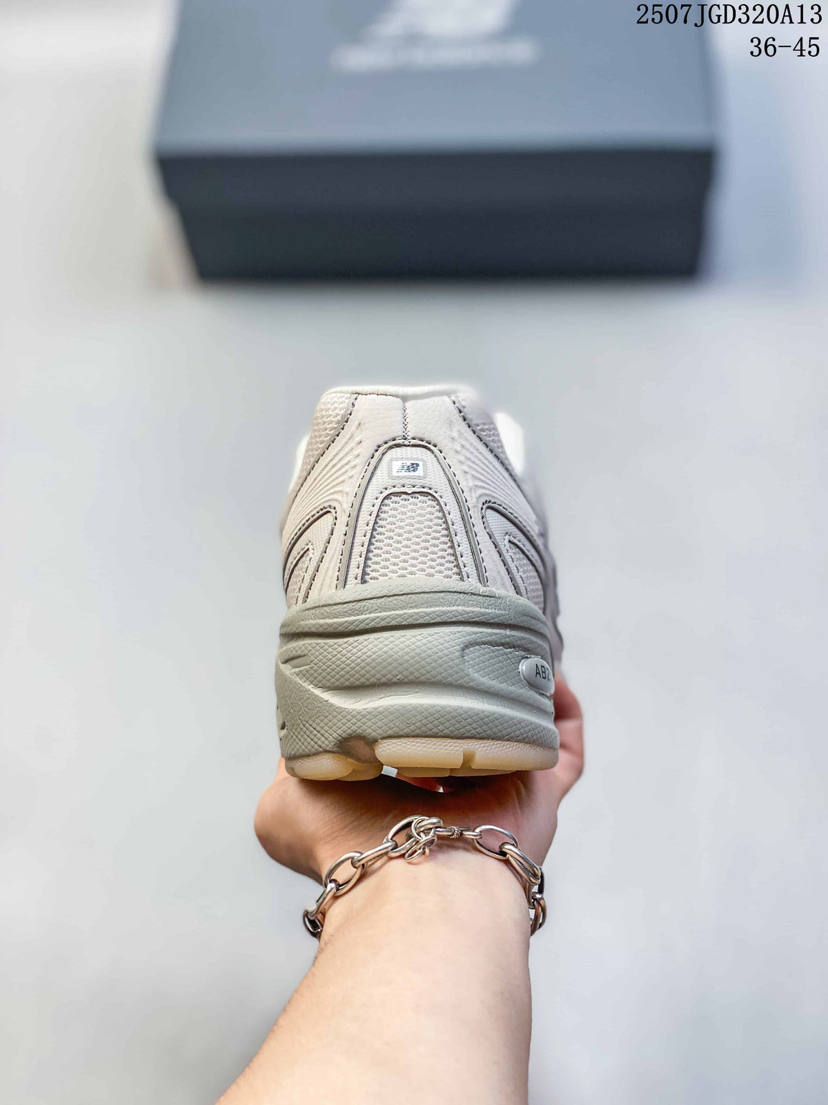 Rear view of the cream sneaker showing the padded heel area, mesh panel and layered sole.
